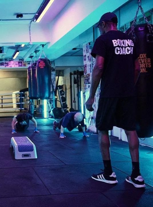 Boxing training partners working hard in a colourful gym